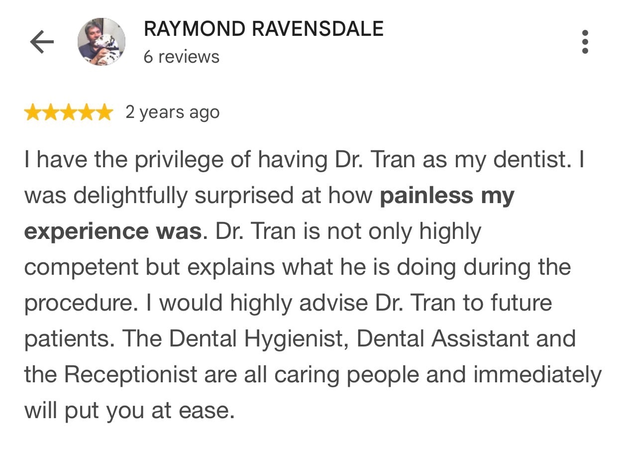 Five-star Google review from Raymond Ravensdale praising Dr. Tran and the caring Deep Cove Dental team.